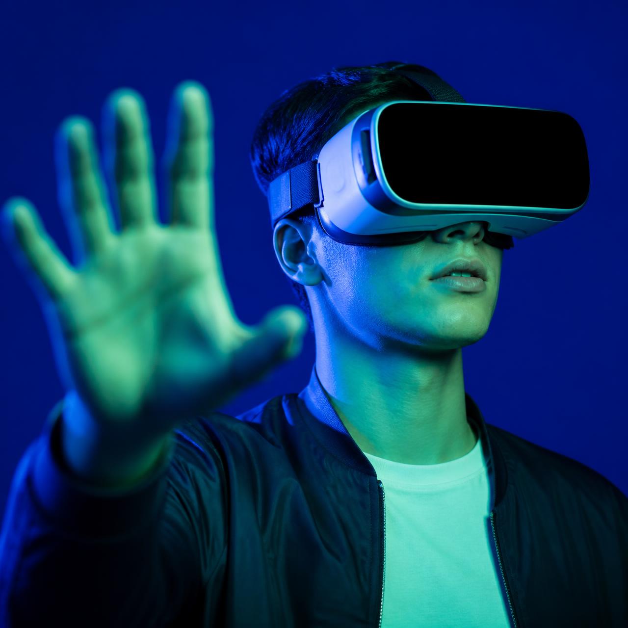 Person using a virtual reality headset lit in blue and green